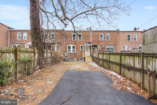 rear view of property with a patio and central AC unit