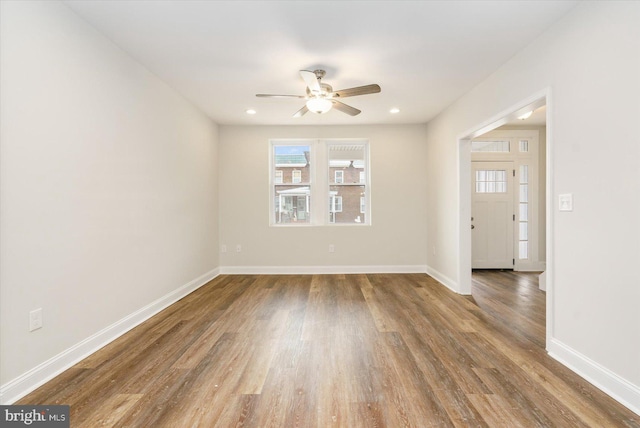 unfurnished room with ceiling fan and wood-type flooring