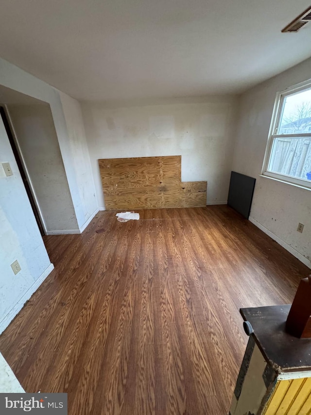 unfurnished living room with dark hardwood / wood-style flooring