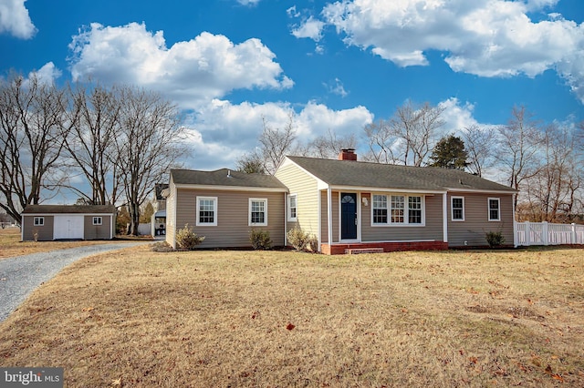 ranch-style home with an outbuilding and a front yard