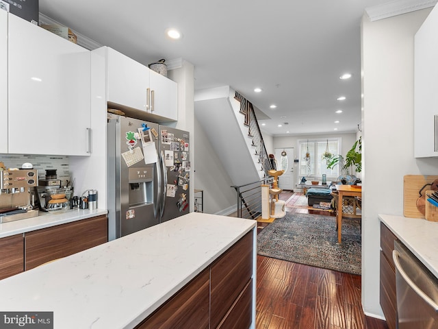 kitchen with tasteful backsplash, stainless steel appliances, dark hardwood / wood-style floors, and white cabinets