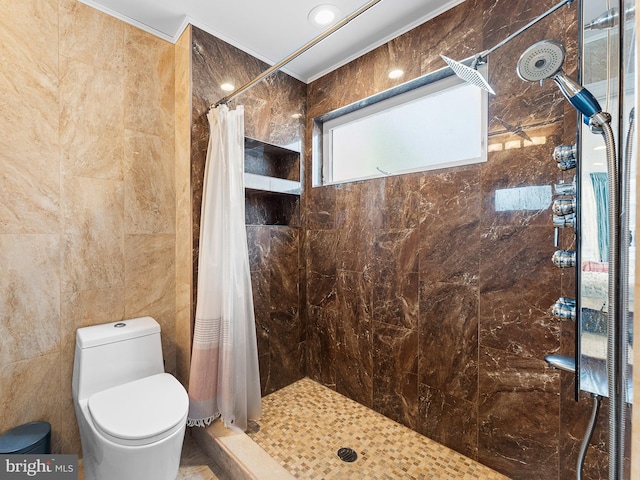 bathroom featuring toilet, curtained shower, and tile walls