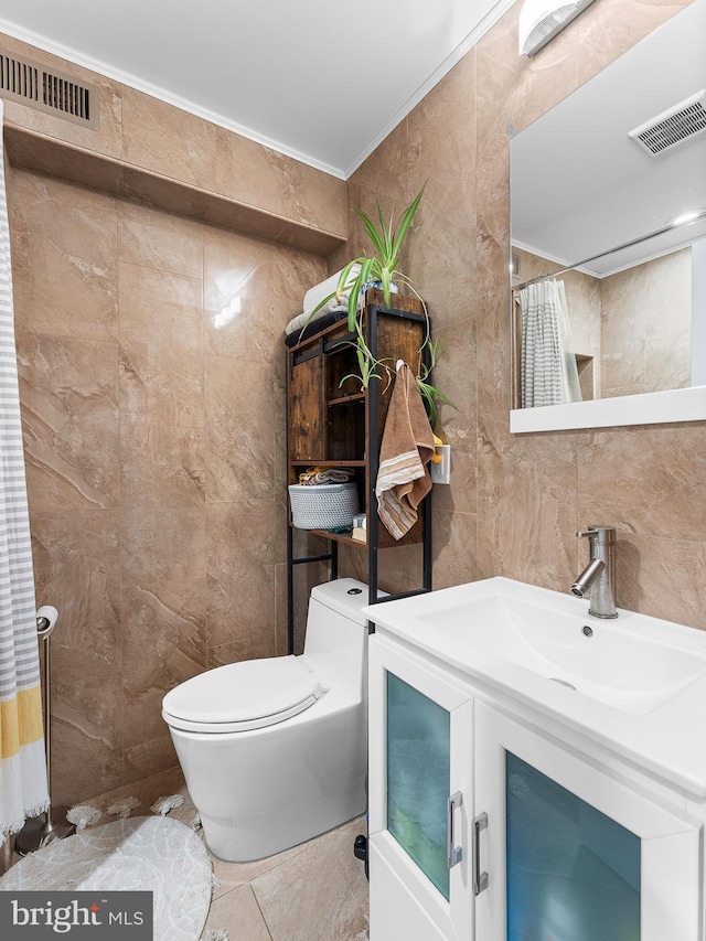 bathroom featuring tile walls, vanity, ornamental molding, toilet, and a shower with shower curtain