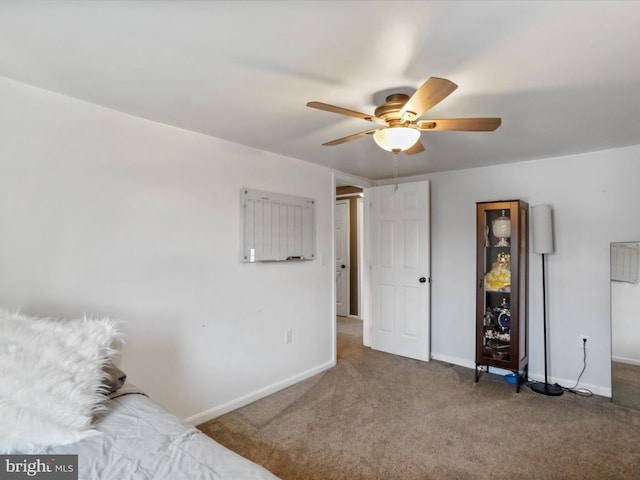 unfurnished bedroom featuring carpet floors, ceiling fan, and baseboards