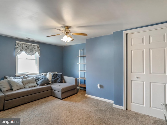 living room featuring visible vents, ceiling fan, light carpet, and baseboards