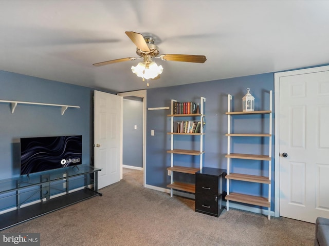 interior space featuring carpet floors, ceiling fan, and baseboards