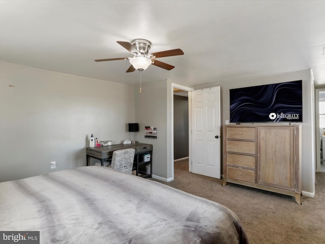 carpeted bedroom with baseboards and a ceiling fan