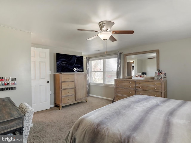 bedroom featuring light carpet, ceiling fan, and baseboards