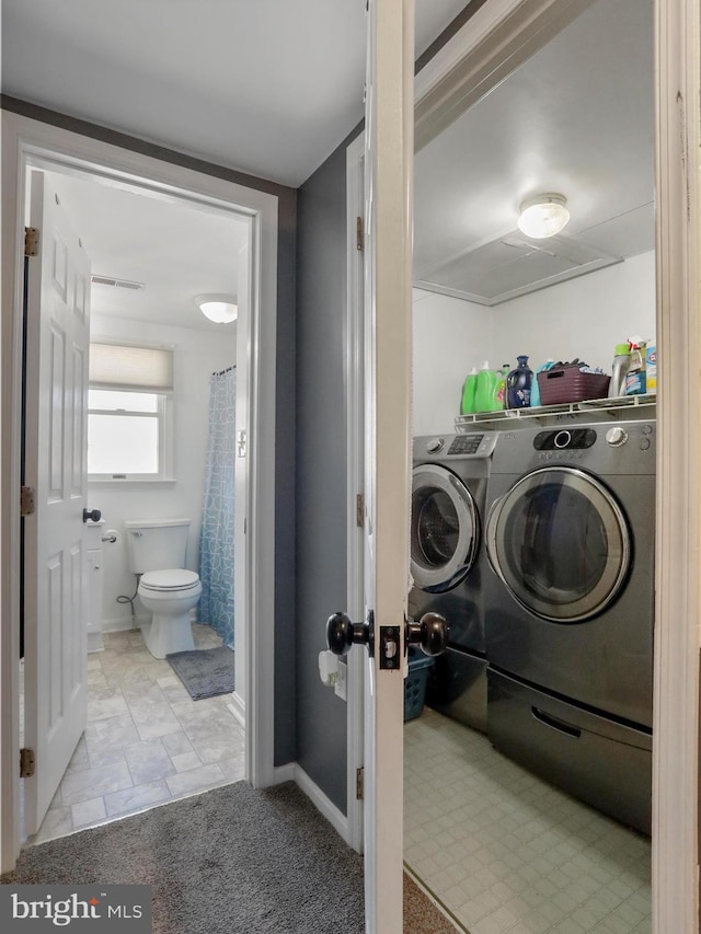 laundry room with laundry area, washer and clothes dryer, visible vents, and baseboards