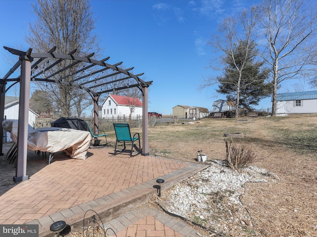 view of patio / terrace with a storage shed, a pergola, and an outdoor structure