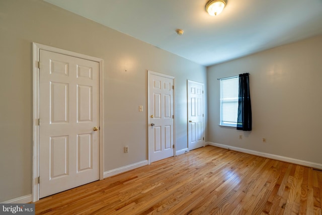 unfurnished bedroom featuring light wood-type flooring