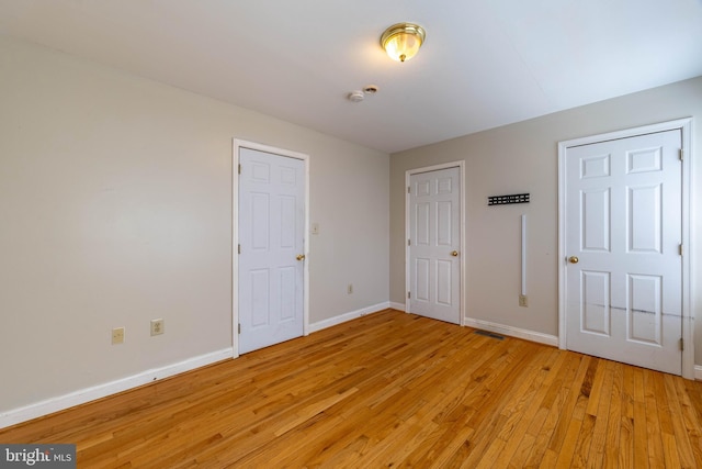 unfurnished bedroom featuring light wood-type flooring