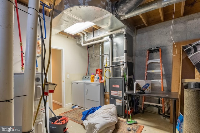 utility room featuring heating unit and washer and clothes dryer