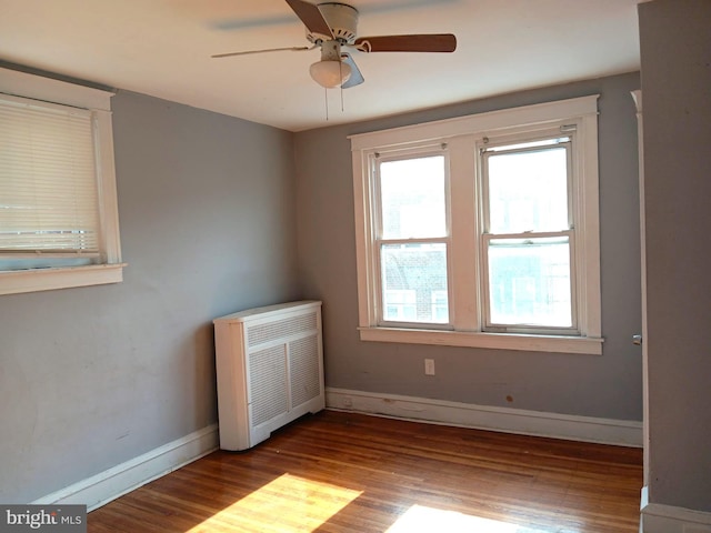 unfurnished room featuring ceiling fan, a healthy amount of sunlight, and light wood-type flooring