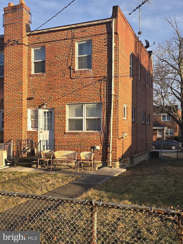 view of front facade featuring a patio and brick siding