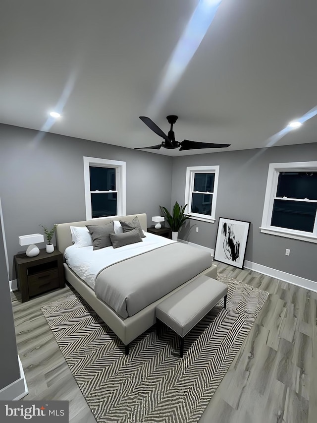 bedroom featuring light hardwood / wood-style flooring and ceiling fan