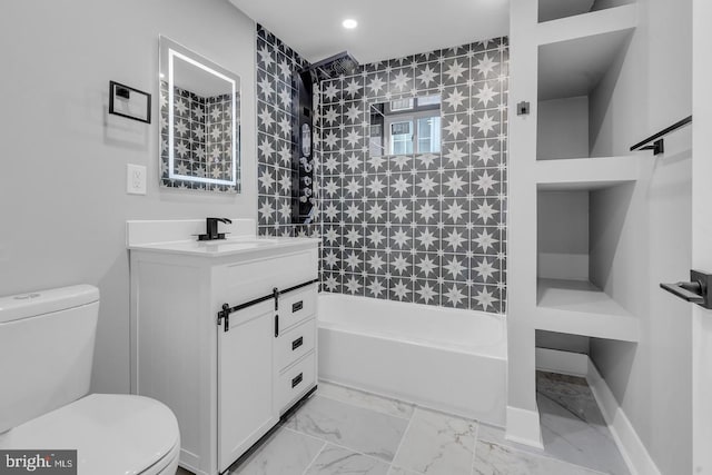 full bathroom featuring tiled shower / bath combo, vanity, and toilet