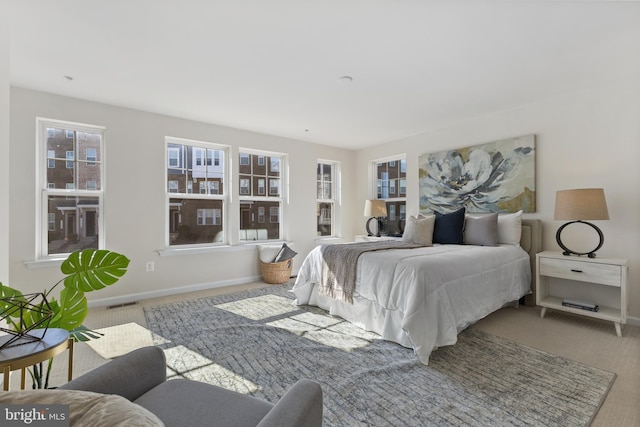 bedroom featuring carpet, visible vents, and baseboards