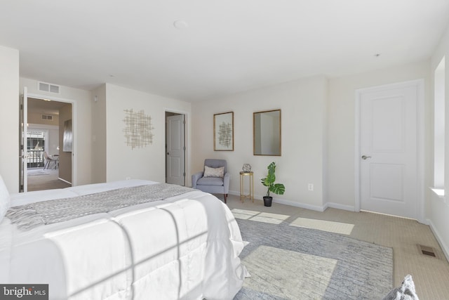 bedroom with light colored carpet, visible vents, and baseboards