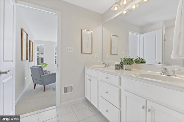 bathroom with double vanity, tile patterned flooring, a sink, and visible vents