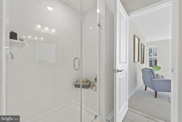 full bathroom with baseboards, a stall shower, and tile patterned floors