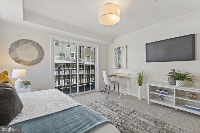 bedroom with light carpet, access to exterior, and baseboards