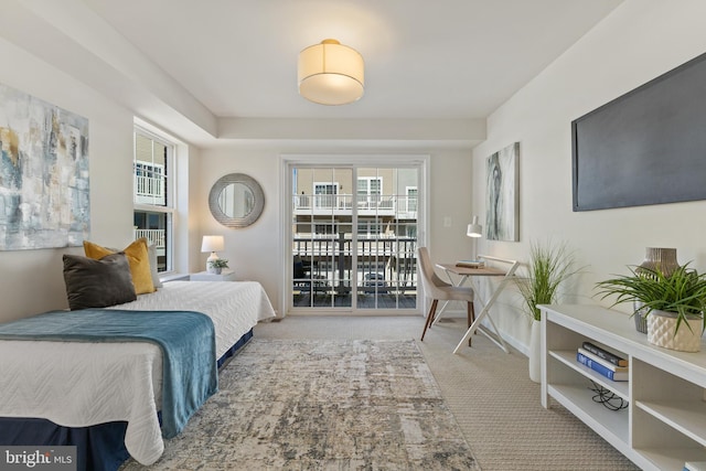 bedroom featuring light carpet, access to exterior, and baseboards