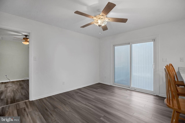 spare room with ceiling fan and dark hardwood / wood-style flooring