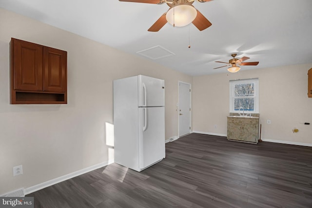 unfurnished living room with dark hardwood / wood-style flooring and sink