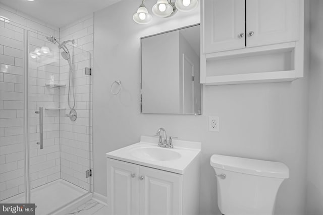 bathroom with vanity, toilet, and a shower with shower door