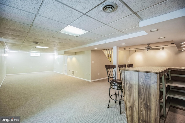 bar featuring carpet, a paneled ceiling, and ceiling fan