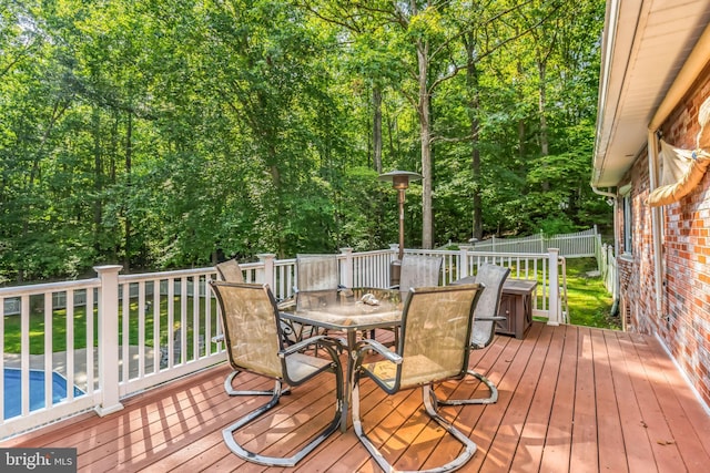 wooden terrace featuring a swimming pool