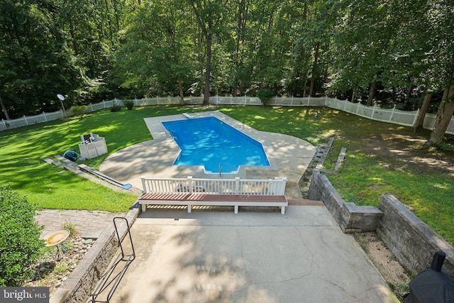 view of swimming pool with a wooden deck, a yard, and a patio