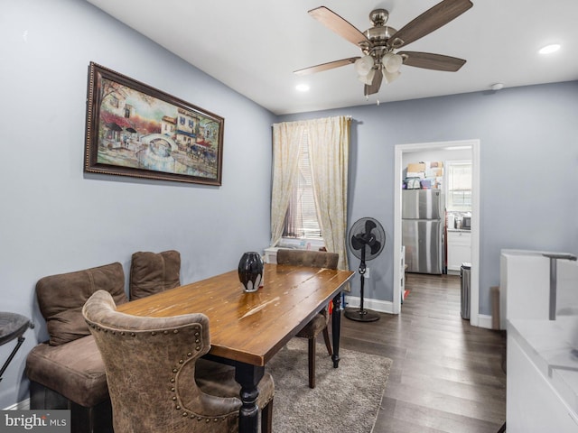 dining area with a wealth of natural light, a ceiling fan, dark wood-style floors, recessed lighting, and baseboards