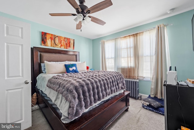 carpeted bedroom featuring radiator heating unit and ceiling fan