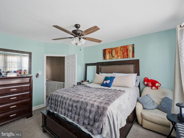 bedroom with baseboards, a ceiling fan, and carpet