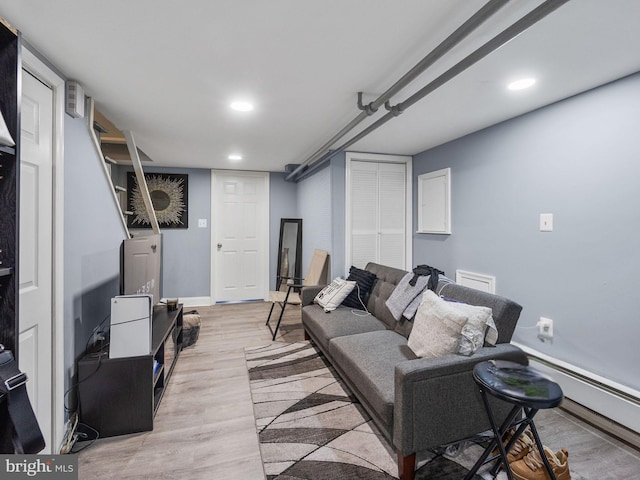 living area featuring recessed lighting, light wood-type flooring, baseboards, and a baseboard radiator