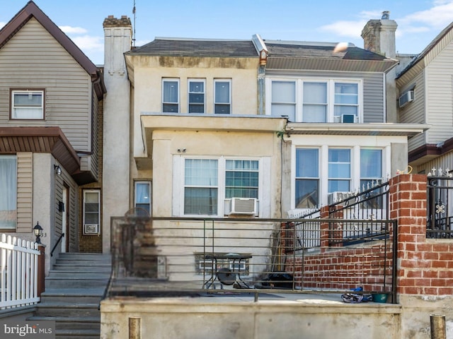 view of front of home with stucco siding and cooling unit