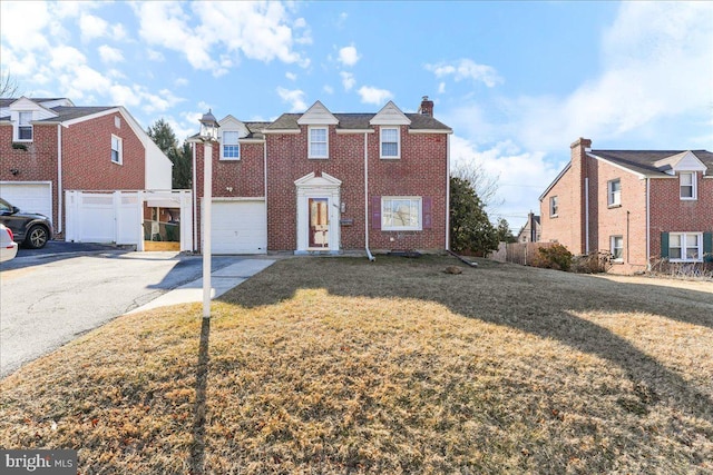 view of front of house with a garage and a front yard