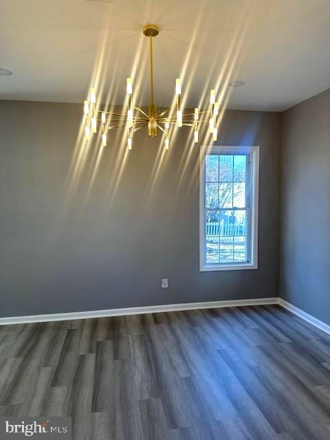 empty room with dark wood-type flooring