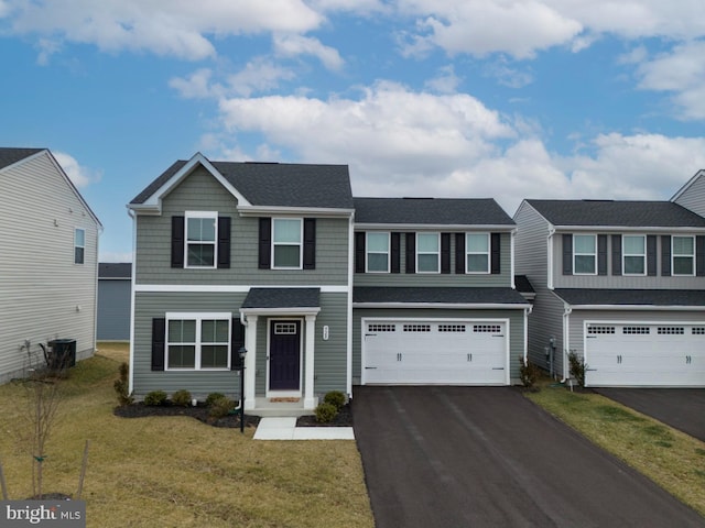 view of front facade with a garage and a front yard