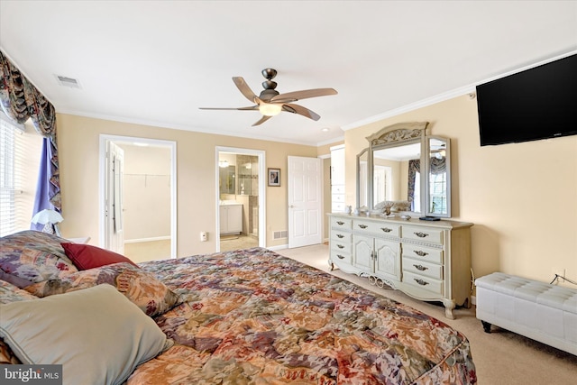 carpeted bedroom featuring ceiling fan, ornamental molding, and ensuite bath