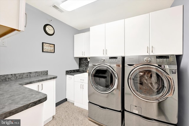 washroom featuring separate washer and dryer and cabinets