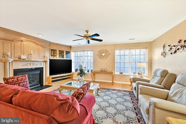 living room featuring crown molding, light hardwood / wood-style floors, and ceiling fan