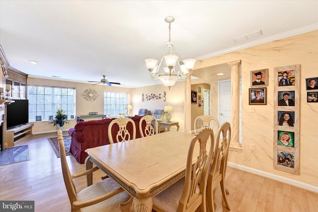 dining space featuring crown molding, ceiling fan with notable chandelier, and light hardwood / wood-style floors