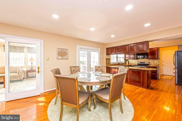 dining room with light wood-style floors, recessed lighting, french doors, and baseboards