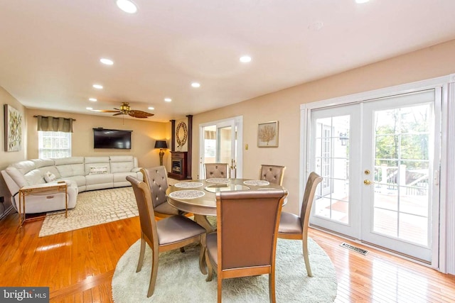 dining area with light wood-style floors, recessed lighting, french doors, and visible vents