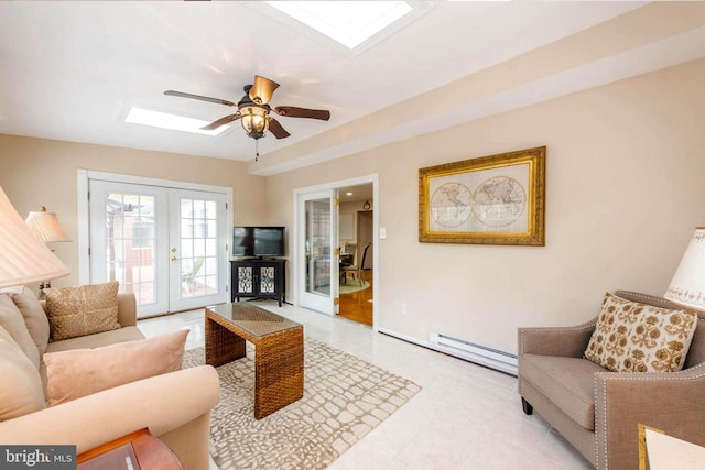 living area featuring ceiling fan, french doors, a baseboard radiator, and a skylight