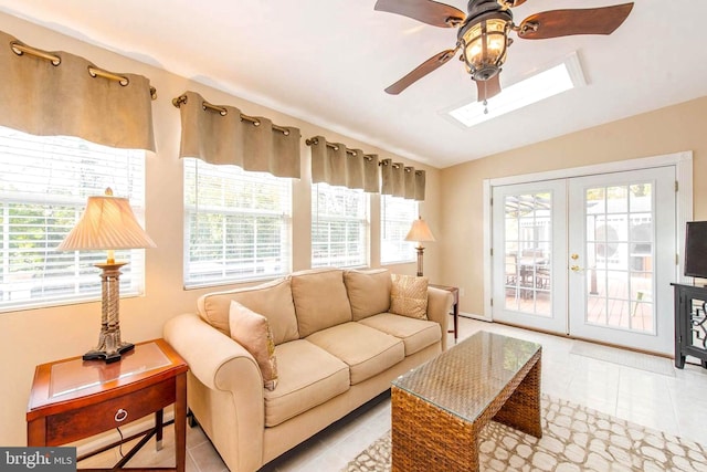 living room with lofted ceiling, french doors, tile patterned flooring, and ceiling fan