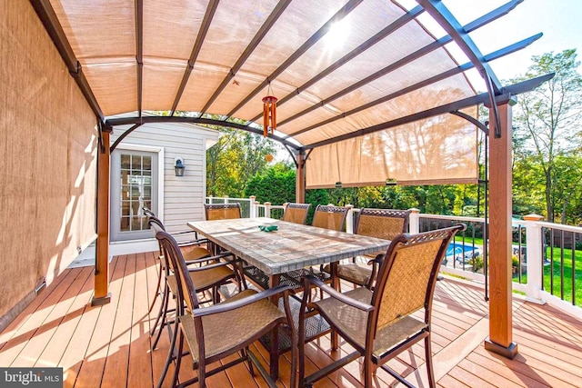 deck with outdoor dining area and a pergola